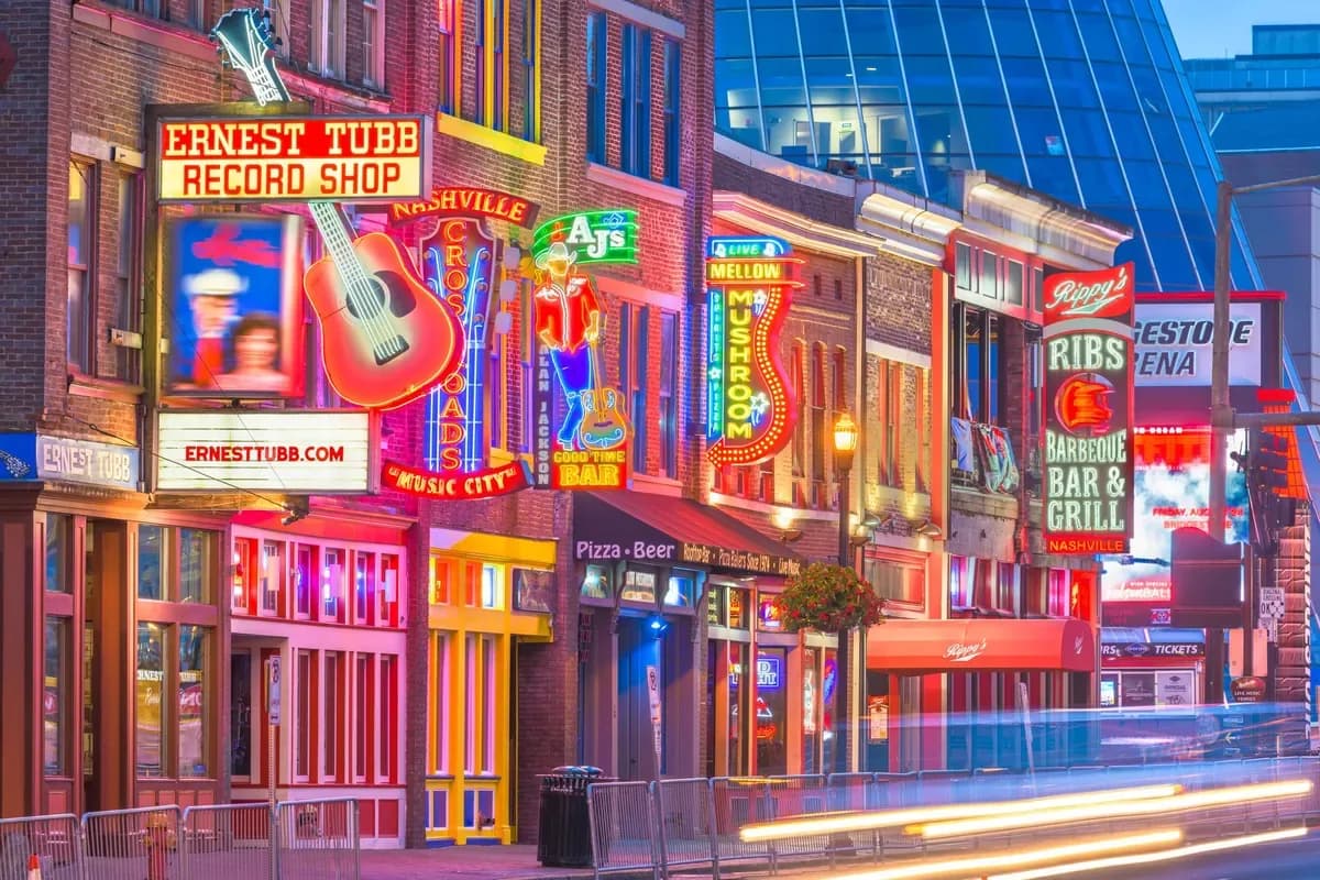 Broadway’s neon music venues and storefronts at dusk